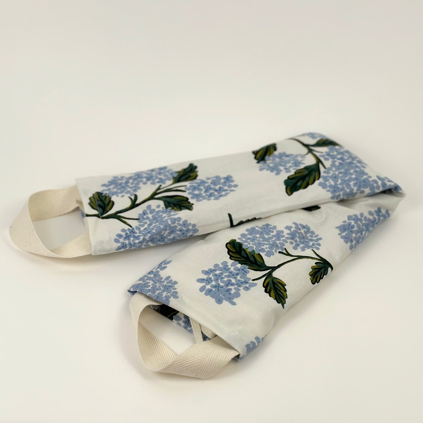 Miche Niche Lavender Neck Wrap in Rifle Paper Co's Hydrangeas pattern demonstrating the product's luxurious feel and overall look