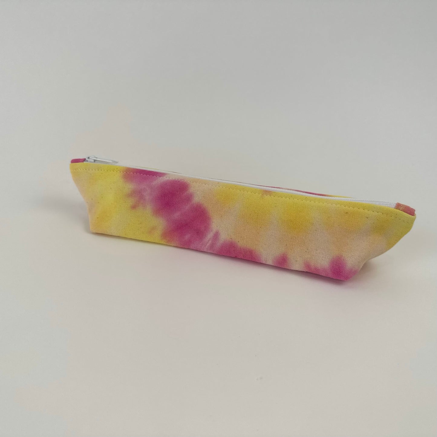 Miche Niche zipper pouch in a hand dyed tie dye pattern of yellow and pink
