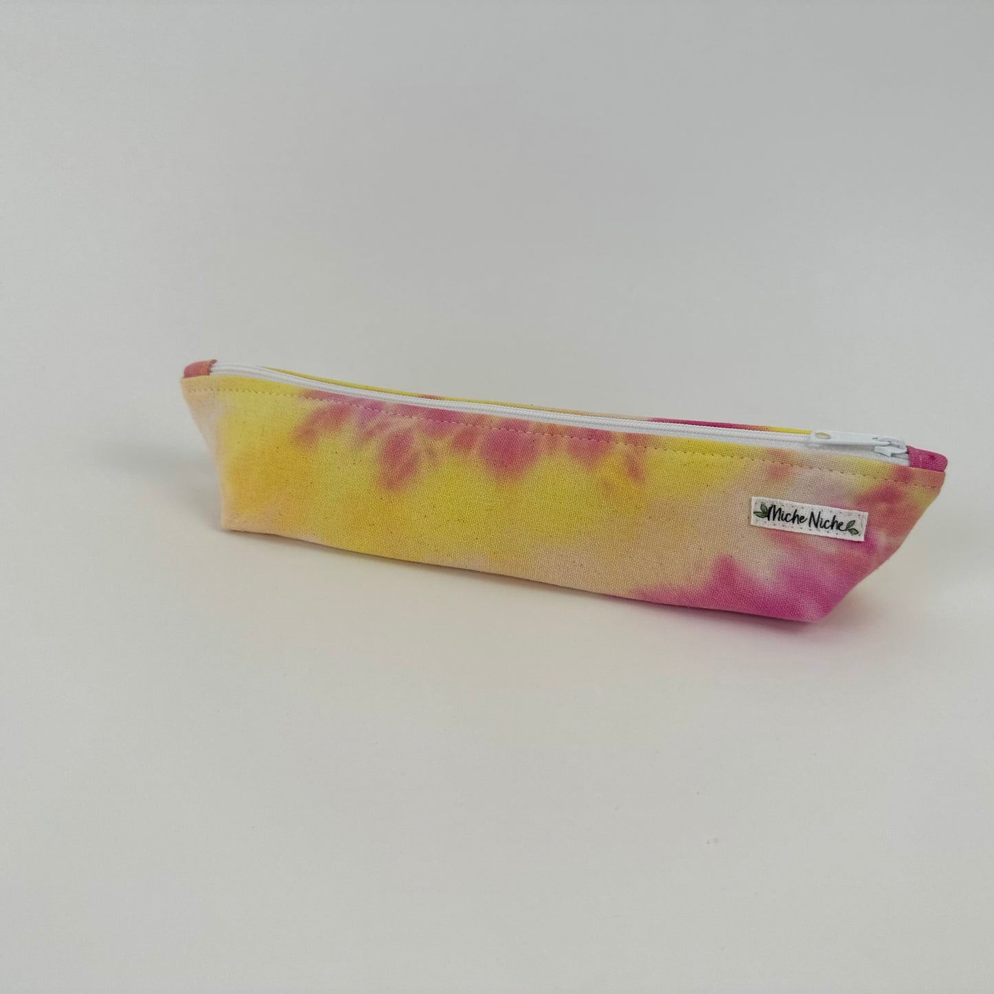 Miche Niche zipper pouch in a hand dyed pattern of pink, yellow and fuchsia. 
